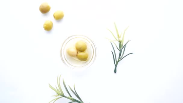 Green olive in a container on white background — Stock Video