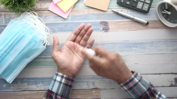 Top view of young man hand using hand sanitizer spray. — Stock Video