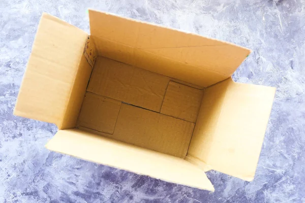 Top view of open empty cardboard box on table. — Stock Photo, Image