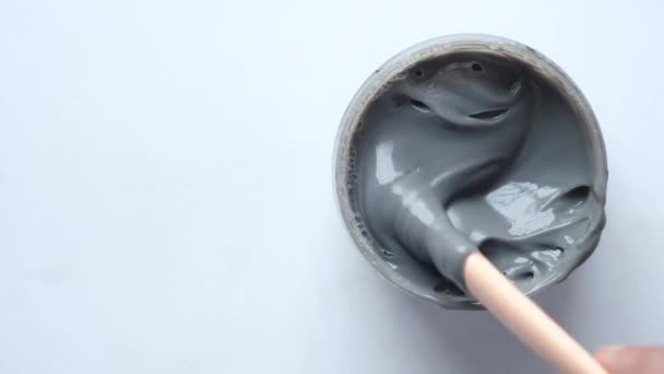 Bubble clay mask in container on white background — Stock Video