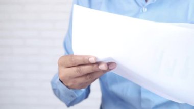 Masadaki kağıt üzerinde finansal verileri analiz eden genç adam. 