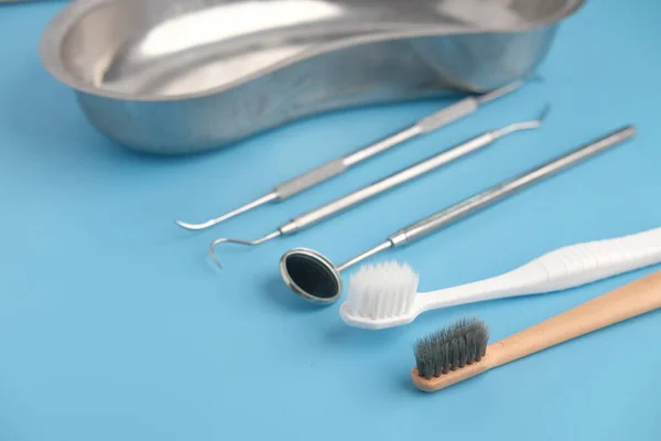 Dental equipment and tooth brush on blue background — Stock Photo, Image