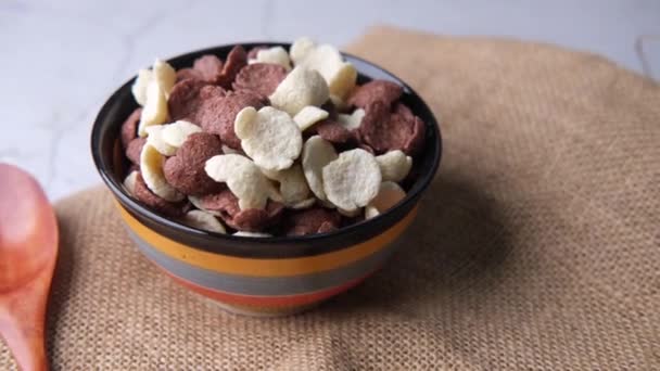 巧克力玉米片放在木制桌子上的碗里 — 图库视频影像