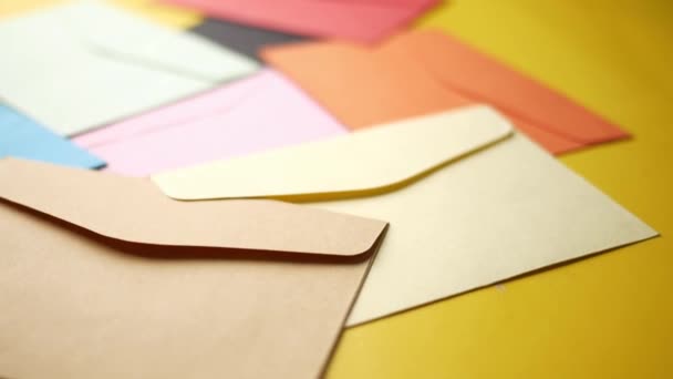 Colorful envelope on yellow background with copy space. — Stock Video