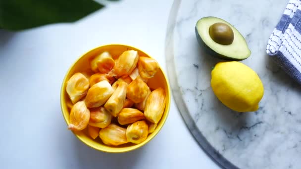 Vista superior de rebanada de frutos de jaca en un tazón en la mesa. — Vídeos de Stock