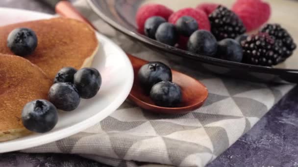 Tasty meal with berries and pan cake in bowl on black background — Stock Video