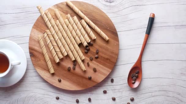 Вафельний рулонний шоколад, кавові зерна та кава на столі  , — стокове відео