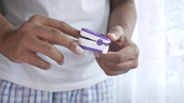 Close up of man hand using pulse oximeter — Stock Video