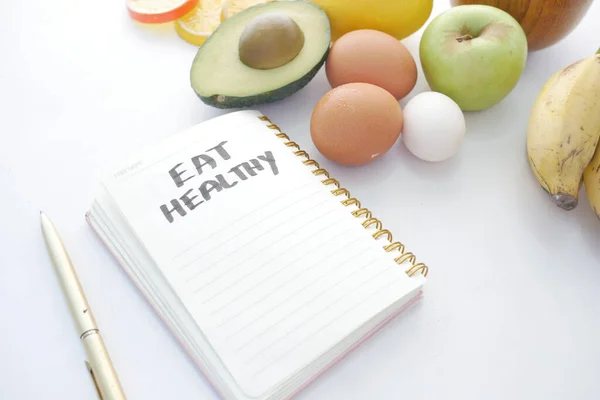 Diet plan with almond nut, dumbbells, banana on table . — Stock Photo, Image