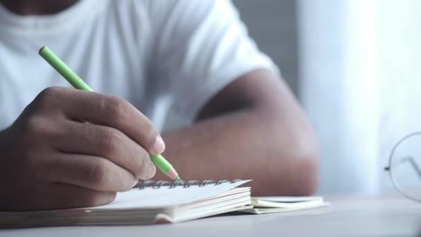 Um estudante escrevendo no bloco de notas no início da manhã — Vídeo de Stock