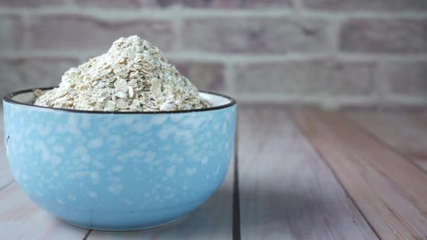 Close up of oats flakes in bowl on table — 비디오