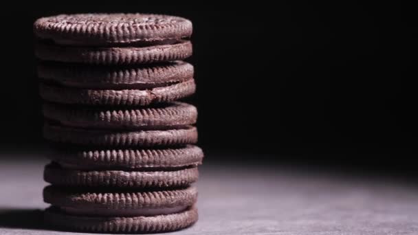 Close up of sweet chocolate cookies against black background — Stock Video