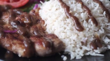 Izgara tavuk, pilav ve salata masada. 