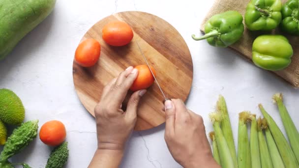 Hand Of Person Cutting Tomatoes On Chopping Board — Stock Video