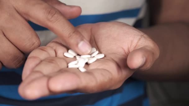 Mans hand with medicine spilled out of the pill container — Stock Video