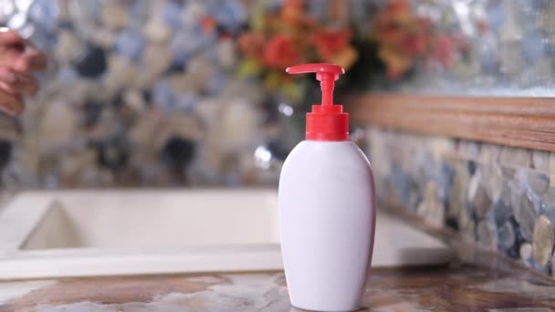 Young man washing hands with liquid soap in the bathroom — Stock Video