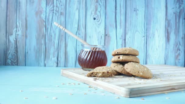 Pila de galletas de chocolate y miel en un frasco en la mesa — Vídeos de Stock