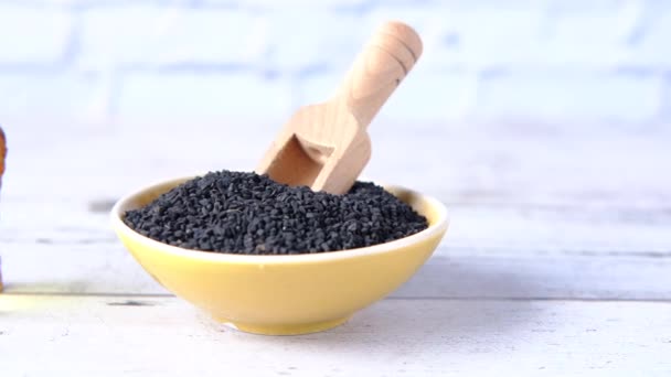 Black Cumin a container with oil in a jar on table. — Stock Video