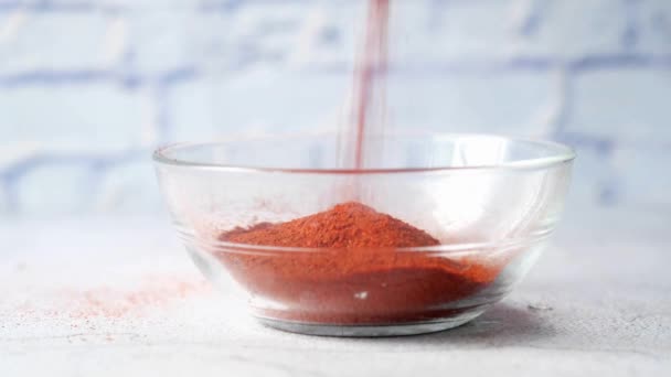 Pouring Chili powder in container on table — Stock Video