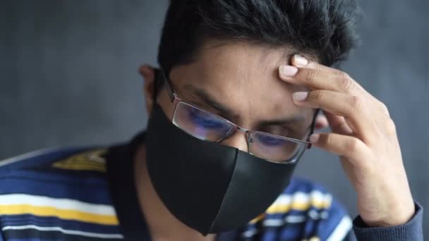 Sick man with protective face mask looking down — Stock Video