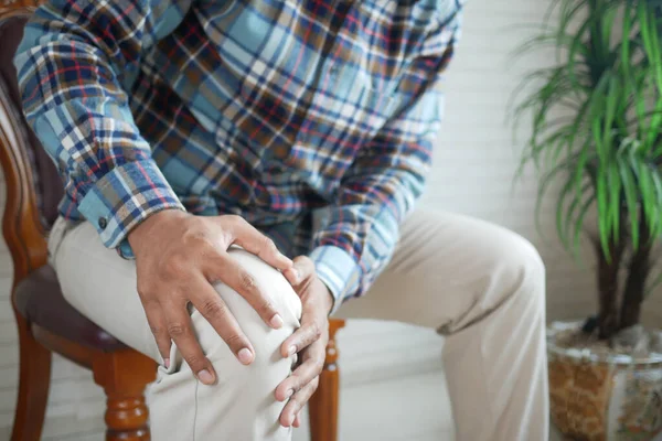 Close up on man suffering knee joint pain — Stock Photo, Image
