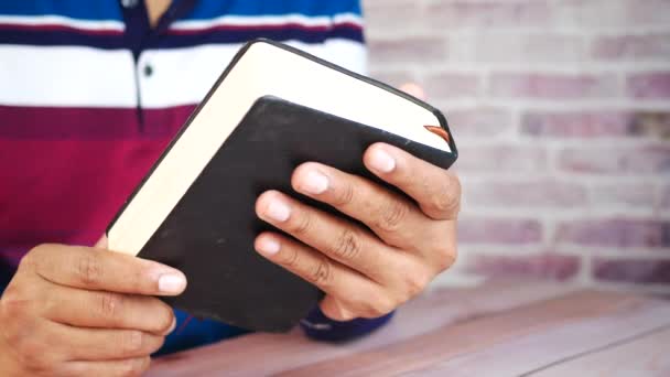 Primer plano de mano joven leyendo un libro — Vídeos de Stock