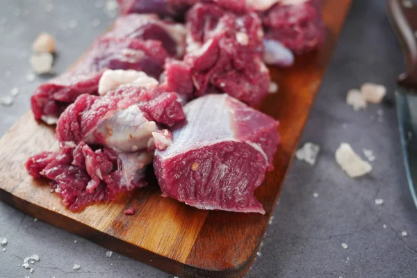 El primer plano de la carne cruda en la tabla de cortar en una tabla de cortar —  Fotos de Stock