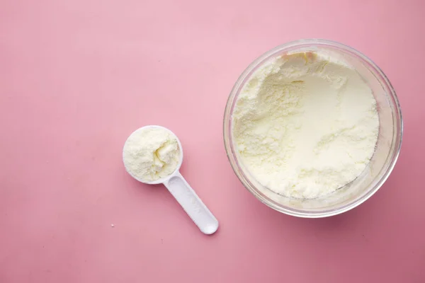 Close up of baby milk powder and spoon on tile background. — Stock Photo, Image