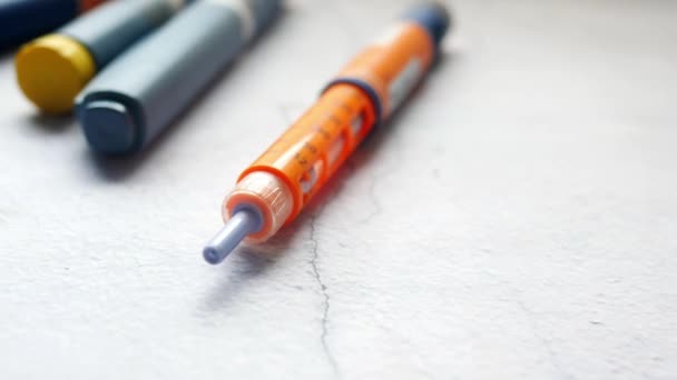 Insulin pens on wooden background, close up — Stock Video