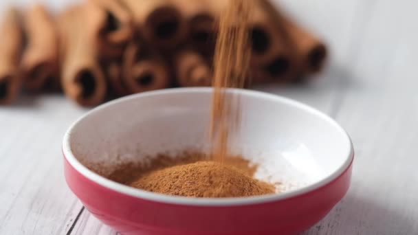 Cinnamon sticks and cinnamon powder on table — Stock Video