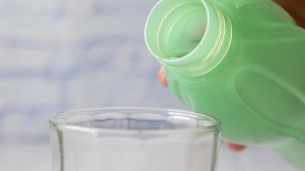 Verter agua en un vaso sobre la mesa — Vídeo de stock