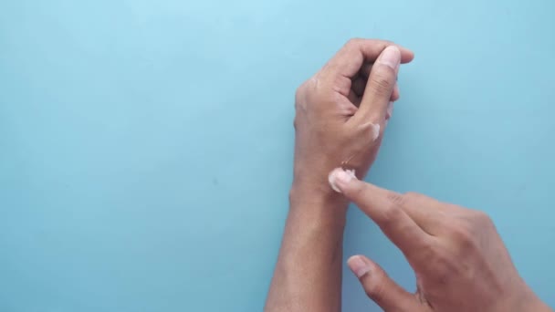 Férfi kéz alkalmazása petróleum zselé kéznél a kék — Stock videók