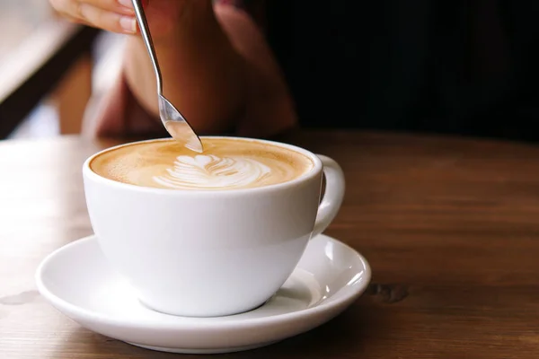 Uma xícara de café tarde com design de forma de flor no topo no café — Fotografia de Stock