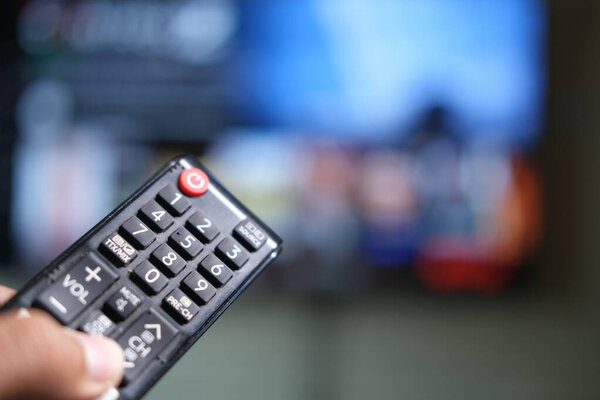 close up of man hand tv remote.