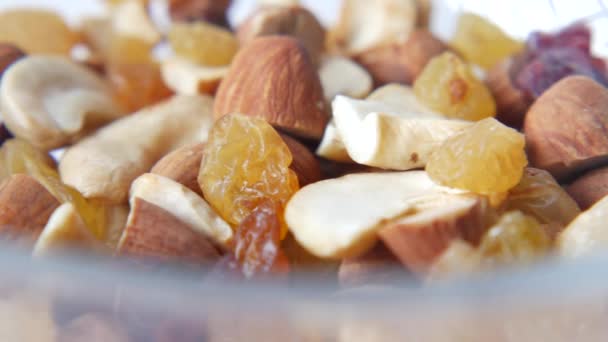 Close up of many mixed nuts in a bowl on white — Stock Video