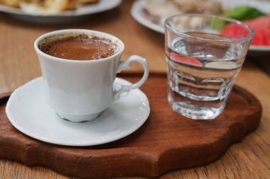  Kafedeki ahşap tepside servis edilen Türk kahvesi ve temiz su..