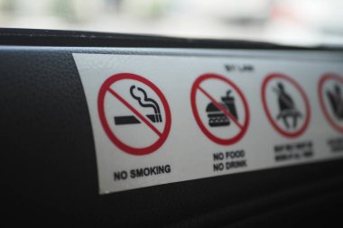 Signs display rules against smoking, eating, and drinking in transit.