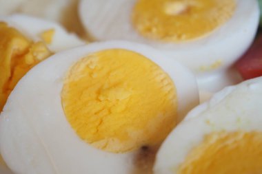 Eggs are perfectly boiled, cut in half, and served for a meal.