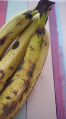 Olgun muzlar sarı rengi gösterir Masada koyu benekler.