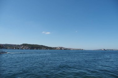 Parlak güneş ışığı Istanbuls körfezindeki sakin suyun üzerine sıcak bir parıltı saçar..