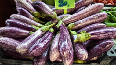 Mor çizgili patlıcanlar yerel bir pazarda düzgün bir şekilde düzenlenir..