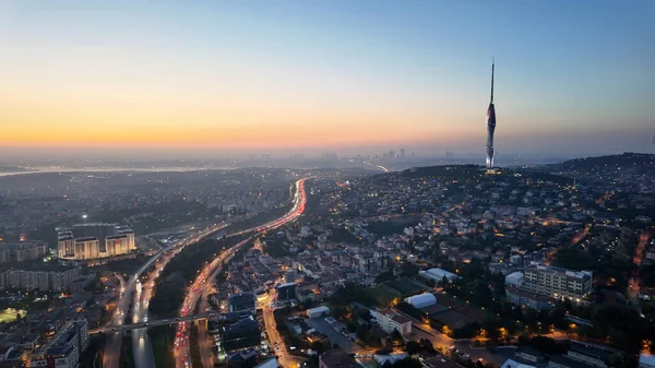 Gün batımında aşağıdaki işlek yollarla bir şehrin ufuk çizgisi görüntüsü.