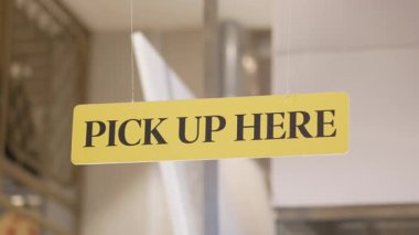 Müşteriler kalabalık bir kafe ortamında çöpçatanlık tabelası görüyorlar..