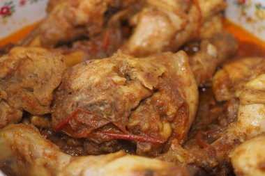Tender chicken pieces simmered in flavorful spices and sauce.