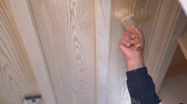 Kalifiye işçiler modern bir odadaki ahşap panellere başvururlar..