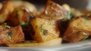 İnsanlar baharat ve otlarla pişirilmiş patateslerin tadını çıkarıyorlar..