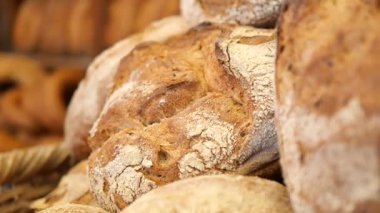 Loaves of bread are cooling on a rack in a small bakery.