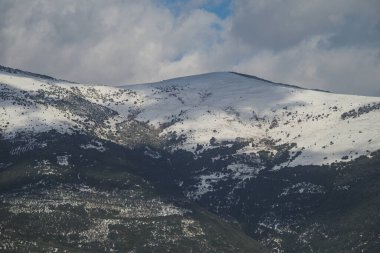 Kar, kış mevsiminde dağın zirvelerinde bulutlarla birlikte mevcuttur..