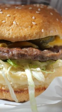 Bu, salatalı, turşulu ve köfteli bir hamburgeri yakından gösteriyor..