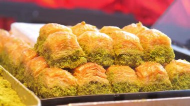 İnsanlar yoğun bir pazarda fındık ve ballı tatlı baklavaları severler..